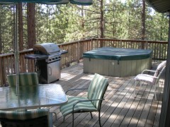 Large upper deck with hot tub, propane grill, and deck furniture