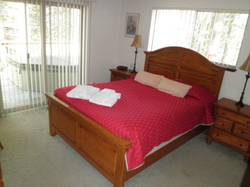 master bedroom, queen bed, linens, towels, dresser, closet, lamps, tv, cable, private bathroom, deck, hot tub